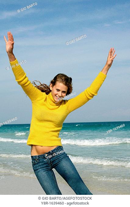 woman jumping next to seaside