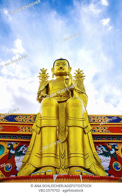 Maitreya, the futur Buddha. Golden Buddha statue in Likkir (Ladakh, India) seatting in a color decorated bench