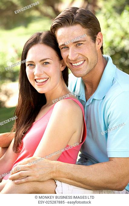 Portrait Of Young Couple Relaxing In Countryside