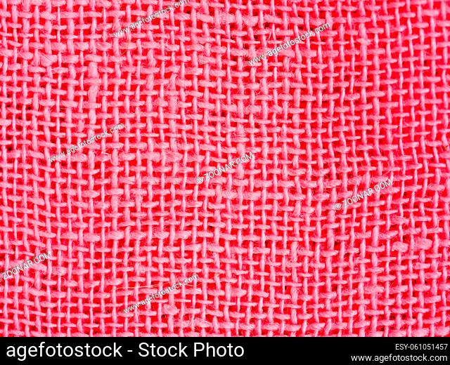 Natural pink cotton fabric weaving close up as background texture