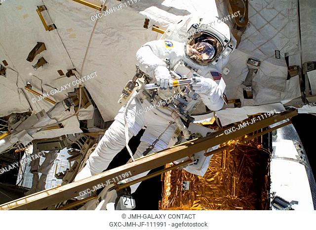 NASA astronaut Alvin Drew, STS-133 mission specialist, participates in the mission's first session of extravehicular activity (EVA) as construction and...