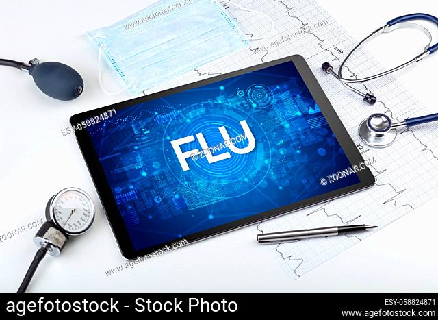 Close-up view of a tablet pc with FLU abbreviation, medical concept