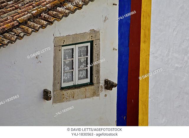 Stone Window in the Medieval Village of Obidos against a Whitewashed Wall