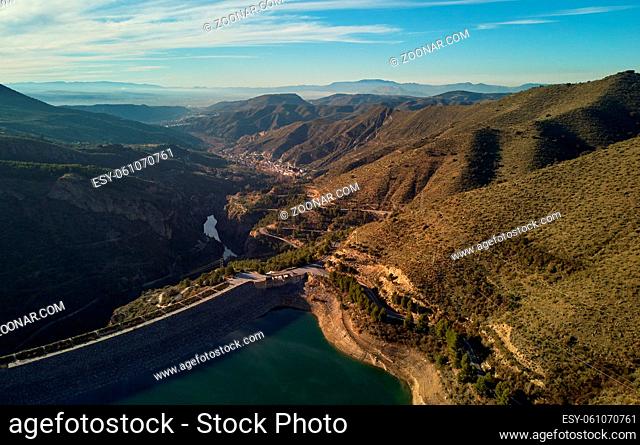 Aerial photography Embalse de Canales Reservoir in Guejar Sierra, province of Granada, Andalusia. Picturesque nature green hills and turquoise clear water view...