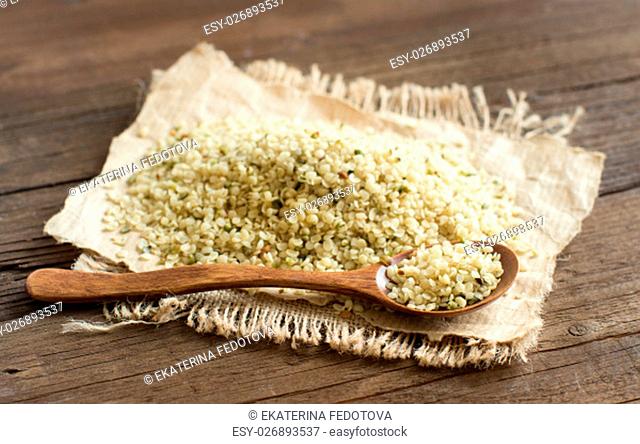 Pile of Uncooked Hemp seeds with a spoon close up
