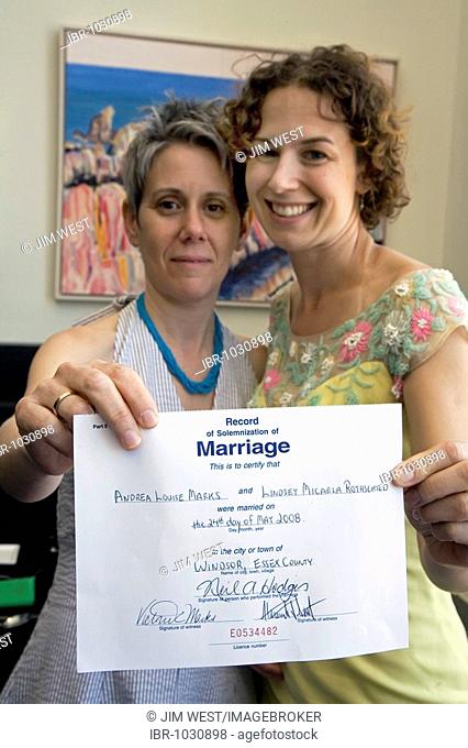 A lesbian couple shows off their marriage certificate after being legally married, Windsor, Ontario, Canada, USA