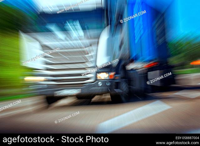 Truck in a blur on the road in motion. The danger of a collision or emergency situation. Violation of rules by truckers. The concept of vigilance at the wheel