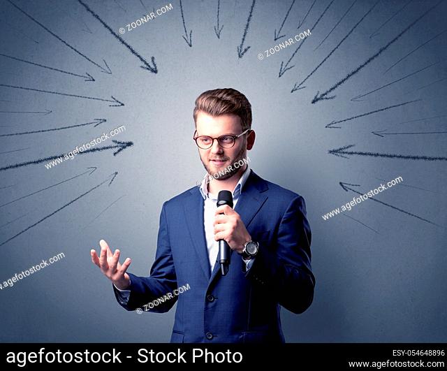 Businessman speaking into microphone with arrows pointing towards his head