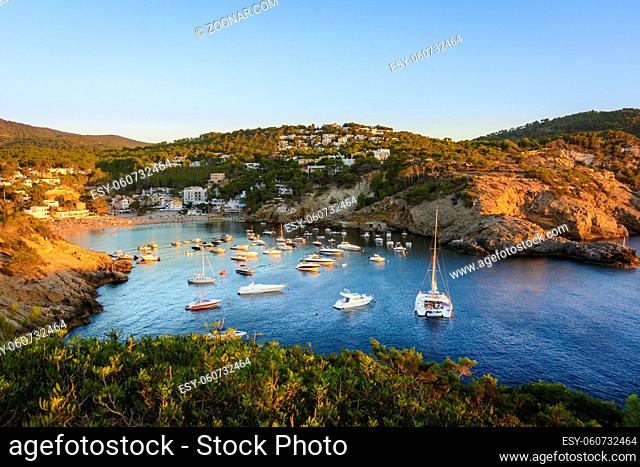 Sunset in the small bay of Cala Vedella, Ibiza island. Part of Balearic islands in Spain