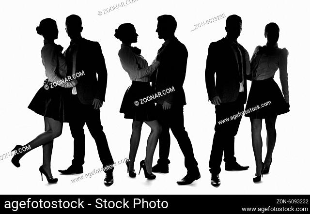 Three silhouettes of a romantic loving couple striking different intimate poses with the man wearing a suit and woman in an elegant miniskirt and stilettos