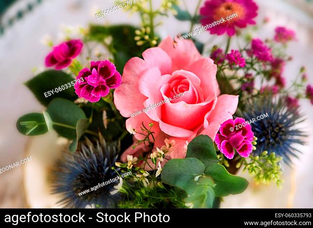 Old coffee cup with flower arrangement on a table