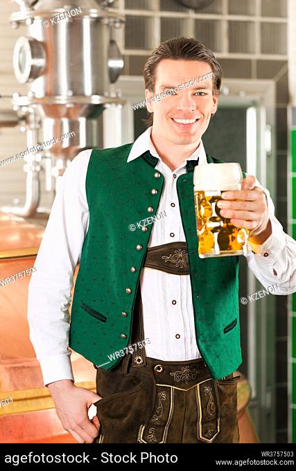 Man in Bavarian Tracht, a brewer, with beer stein in brewery