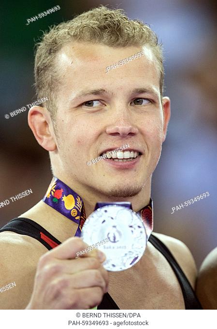 Germany's Fabian Hambuechen shows his silver medal for the Gymnastics Artistic - Men's Floor Exercise at the Baku 2015 European Games in National Gymnastics...