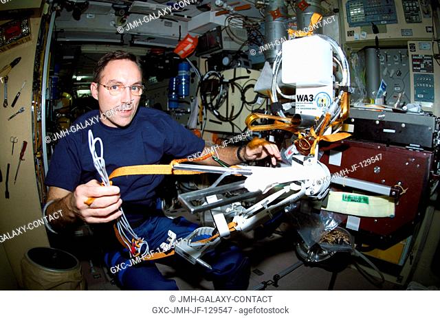 Astronaut Carl E. Walz, Expedition Four flight engineer, works with the Amateur Radio (HAM) WA3 Antenna Assembly in the Zvezda Service Module on the...