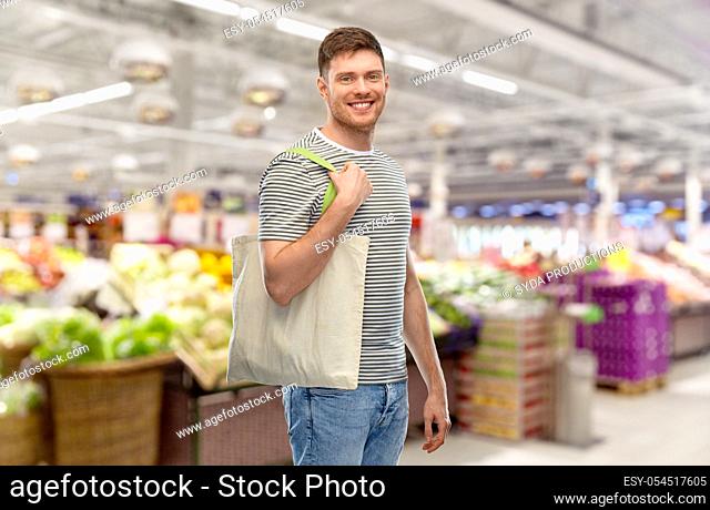 man with reusable canvas bag for food shopping