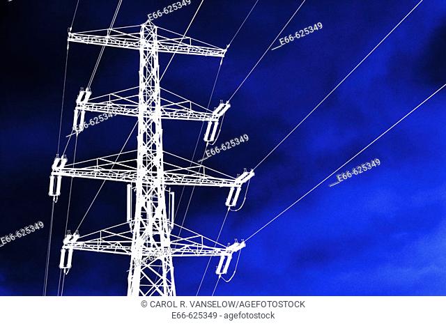 high tension electrical wires and pylon. reversed image with dramatic blue sky