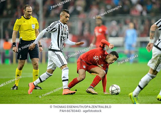 Munich's Thiago Alcantara (red) vies with Turin's Roberto Pereyra during the Champions League match between FC Bayern Munich and Juventus Turin at Allianz Arena...