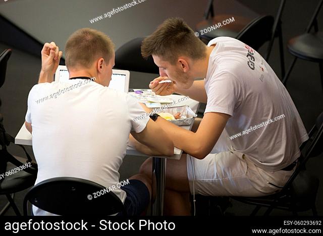 Belarus Minsk 06 August 2016 The Park of High Technologies. Competitions programmers.Students eat and work. Lunch at work