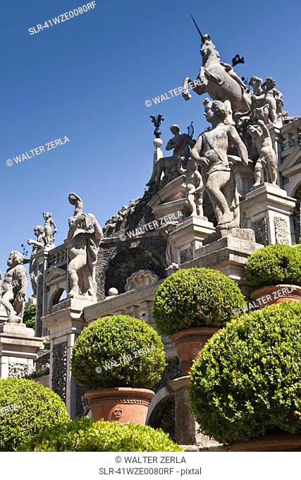 Shrubs with ornate statues and columns