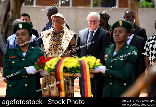 01 November 2023, Tanzania, Songea: German President Frank-Walter Steinmeier lays a wreath at the monument in Songea's Memorial Park together with descendants...