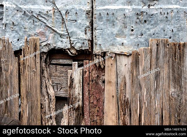 An old repaired fence of wood and metal, somewhere in the town of Amalfi, Italy