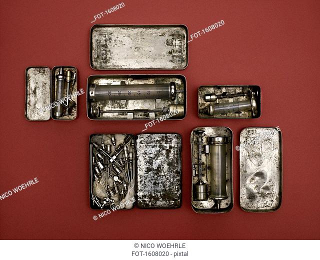 Directly above shot of old-fashioned medical tools on red background