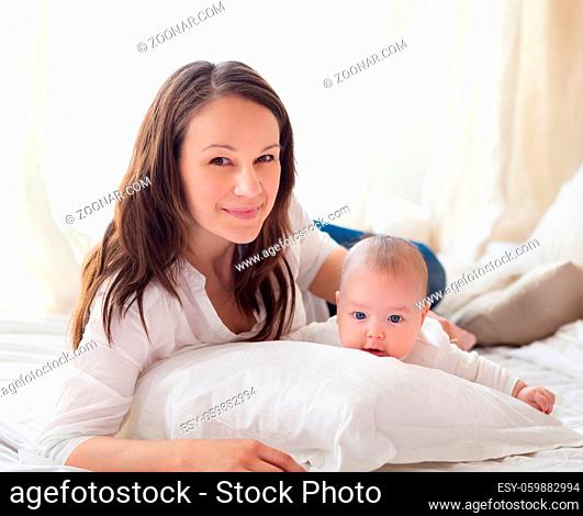 Portrait of a happy mother and child laughing and playing