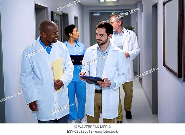 Doctors interacting with each other in corridor