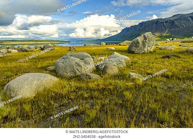 View over Vietas in Stora sjöfallets national park, with big rocks and sky reflecting in the lake, Laponia, Gällivare county, Swedish Lapland