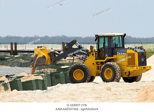 Heavy equipment building sand-filled barricades along the shoreline of Mobile Bay in response to the BP oil spill. Baldwin County, Alabama. June 2010