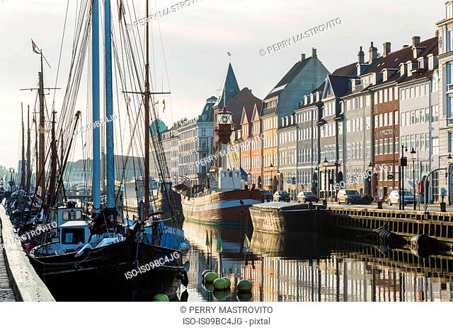 Moored sailboats and 17th century town houses on Nyhavn canal, Copenhagen, Denmark
