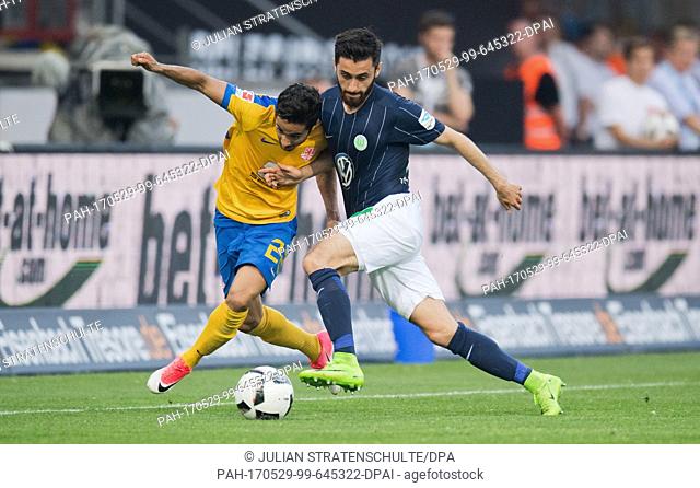 Braunschweig's Salim Khelifi and Wolfsburg's Yunus Malli (r) vie for the ball during the German Bundesliga football match between Eintracht Braunschweig and VfL...