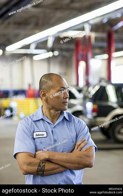 Portrait of Pacific Islander car mechanic in auto repair shop