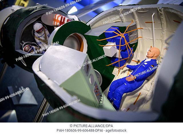 06 June 2018, Germany, Kuenzelsau: A figure representing ESA astronaut Alexander Gerst can be seen in the model of a Sojus spaceship during an event for the...