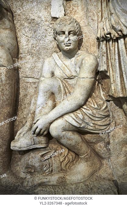 Close up of Roman Sebasteion relief sculpture of Meleager and Atalante Aphrodisias Museum, Aphrodisias, Turkey. . . Meleager sits on a rock tying his sandal