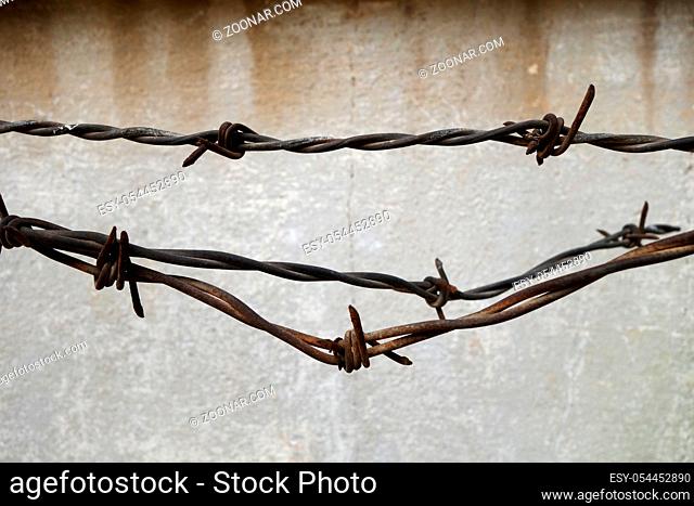 Rusted cross spiked fence with vintage wall