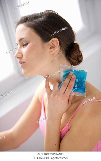 Woman using a hot-cold gel pack treatment to releive pain
