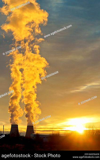 thermal power station, thick with pipe smoke, the smoke from the chimneys at sunset