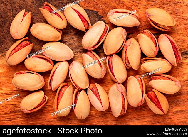 Table top view - turkish red roasted pistachios on wood board