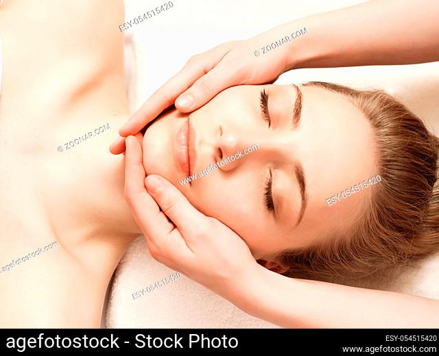 Spa. Pretty woman enjoying anti-aging facial massage