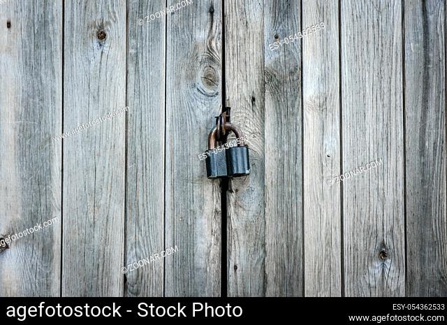 Old lock on the door. lock on the door of an old farmhouse . true village style. close-up. focus on lock