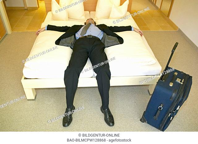 tired man sleeping in hotel