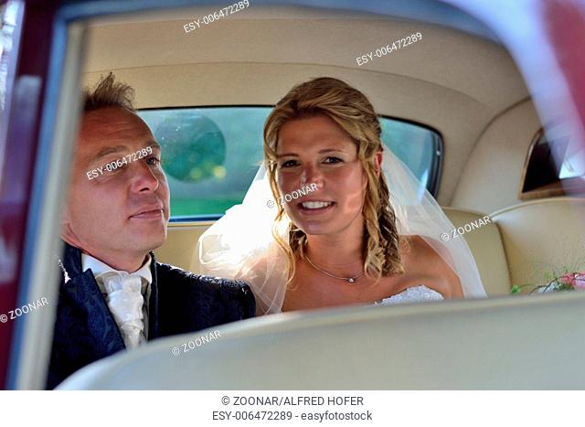 Bride and groom in wedding car