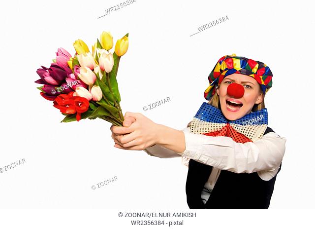Pretty female clown with flowers isolated on white