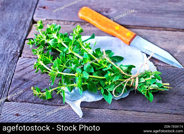fresh marjoram sprig on the wooden table