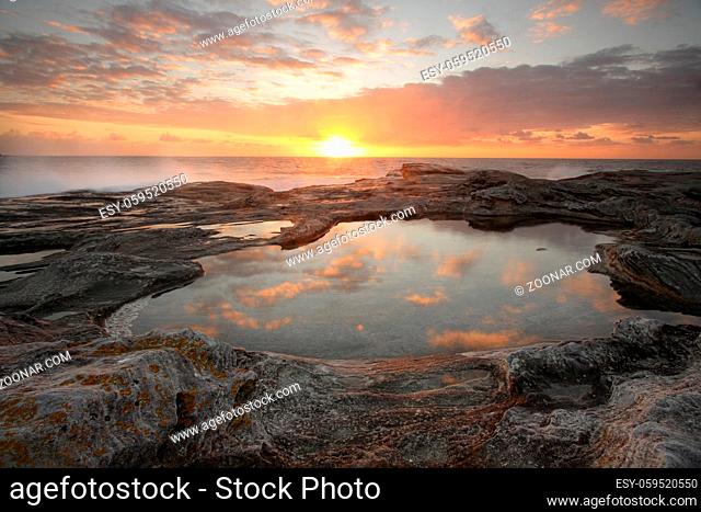 Yena Bay rockshelf sunrise reflections in one of the rockpools