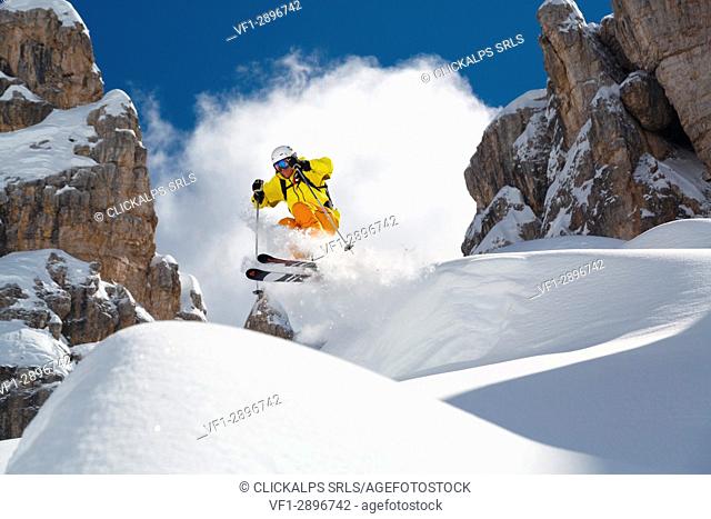 Skier jumps in the fresh snow framed by the rocky peaks of Cinque Torri Cortina D'Ampezzo Dolomites Belluno Veneto Italy Europe