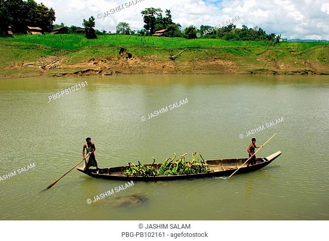 A boat carries fruits through the Sangu River Bandarban, Bangladesh July 2008