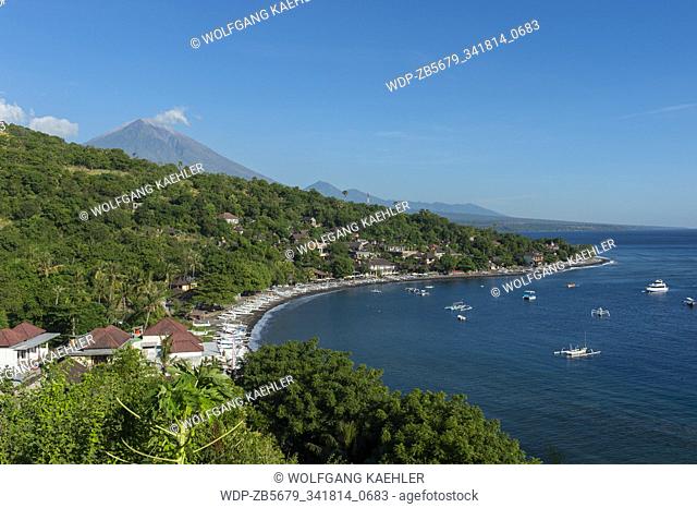 View of a bay in Amed with traditional Balinese fishing boats (Junkung) and Mount Agung (an active volcano), East Bali, Indonesia