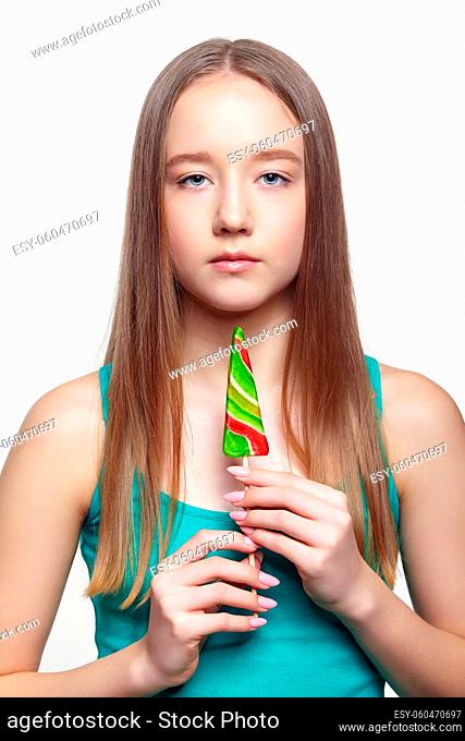 Teenager girl with lollipop in hands. Sweet tooth concept